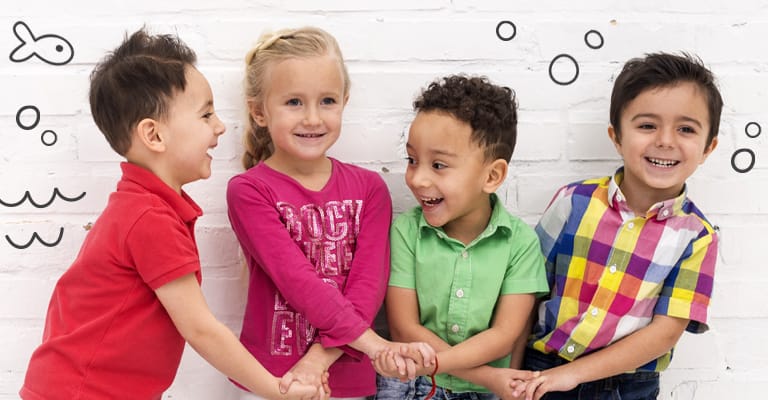 Children holding hands and smiling
