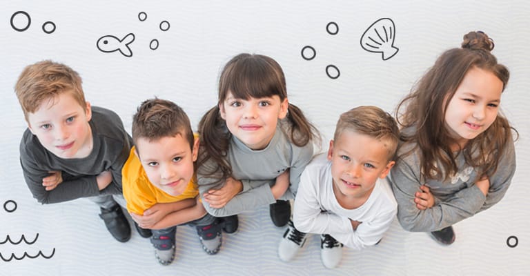 Children holding hands and smiling